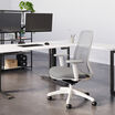 vari ascent chair in fog grey in office setting with professional sitting